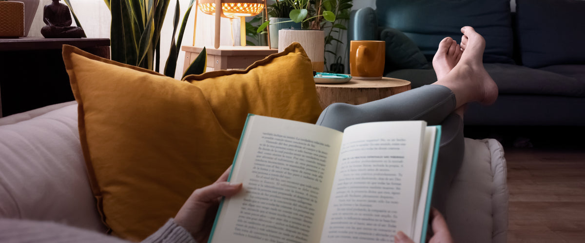 Relaxing with a book with Dakshin Tea in a cup.